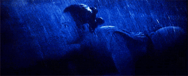 a painting of a man and a woman kissing in the rain
