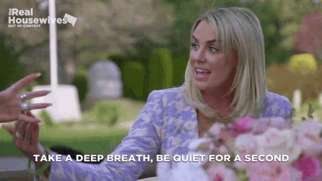 a woman sitting at a table with the words take a deep breath be quiet for a second on the bottom