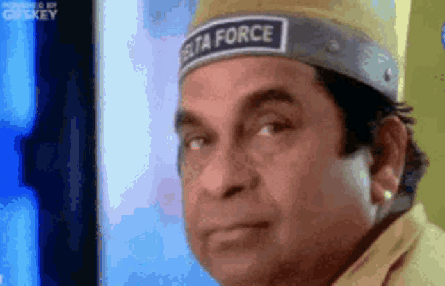 a man wearing a hat with the word delta force on it .