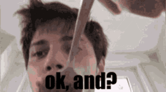 a man is holding a spoon in his mouth with the words ok and written above him