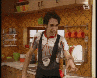 a man standing in a kitchen with a sign that says ' shalom '
