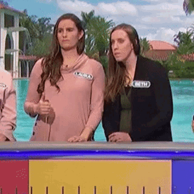 two women standing next to each other with one wearing a name tag that says " claudia "