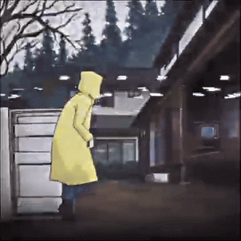 a person in a yellow raincoat with a hood is standing in front of a building