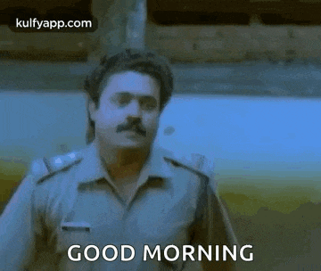 a man in a police uniform is standing in front of a train and says good morning .