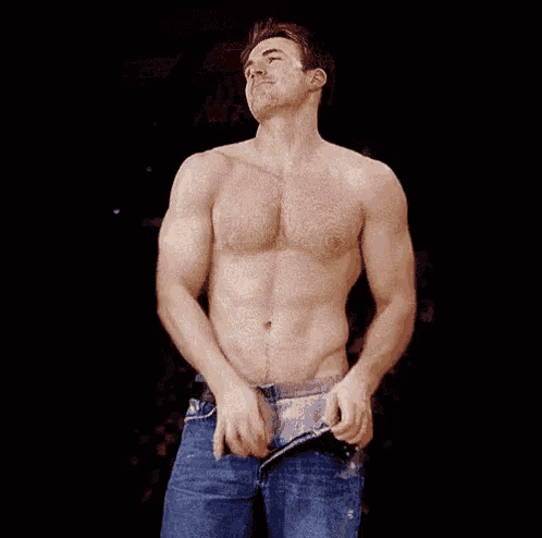 a shirtless man is taking off his pants and smiling