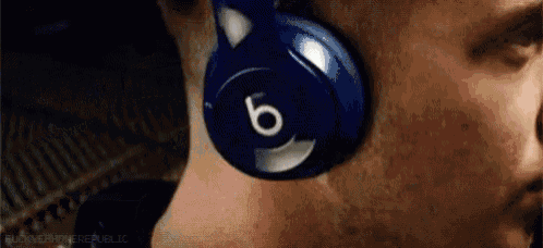 a man wearing a pair of blue beats headphones .