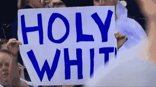 a person holding a sign that says holy white