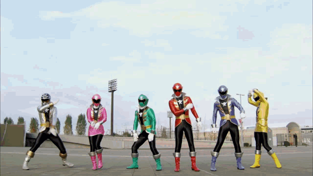 a group of power rangers are standing in front of a large silver sword