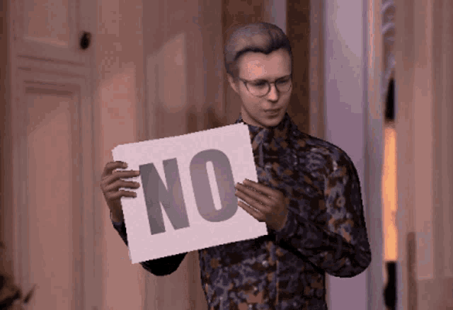 a man holding a sign that says no