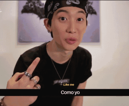 a man with a bandana on his head is giving the middle finger and says like me como yo