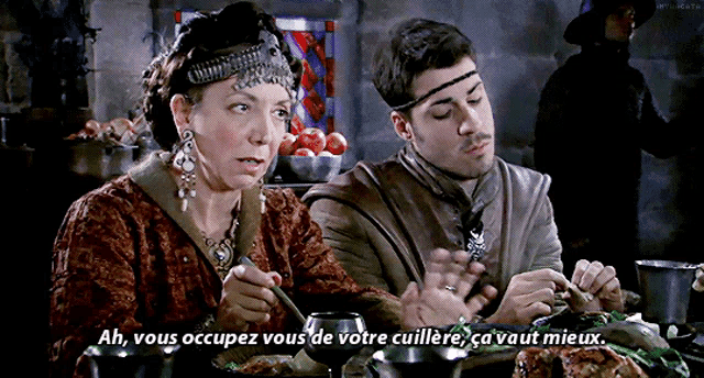 a man and a woman are sitting at a table with a caption that says ah vous occupez vous de votre cuillere