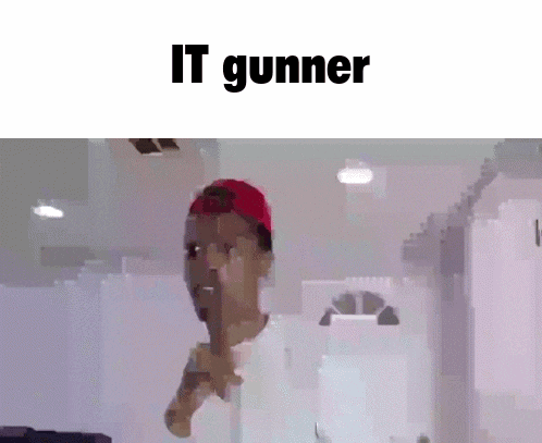 a man wearing a red hat and a white shirt is holding his finger to his mouth and says `` it gunner '' .