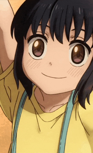 a little girl with a yellow shirt and blue suspenders smiles