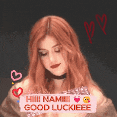 a woman with red hair is holding a sign that says hiii namii good luckieee