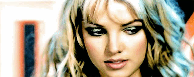 a close up of a woman 's face with blue and blonde hair