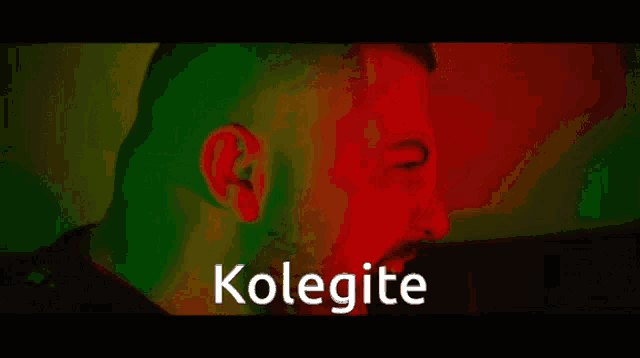 a close up of a man 's face with the word kolegite written in white letters .