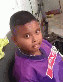 a young boy is wearing a purple shirt that says spar