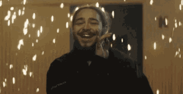 a man with a beard is smiling in front of a sign that says 10