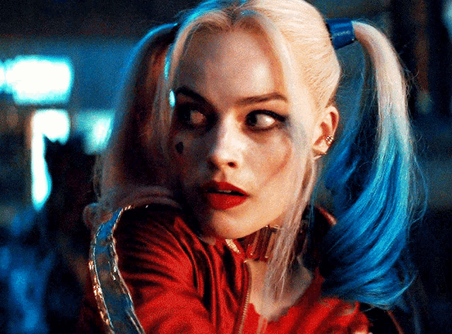 a close up of harley quinn with blue hair