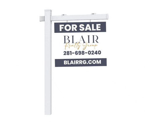 a for sale sign for blair realty group is on a white pole