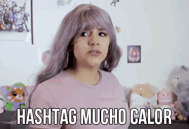 a girl with purple hair and a pink shirt says hashtag mucho calor