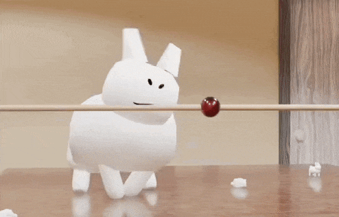 a white object is hanging from a string next to a red object .