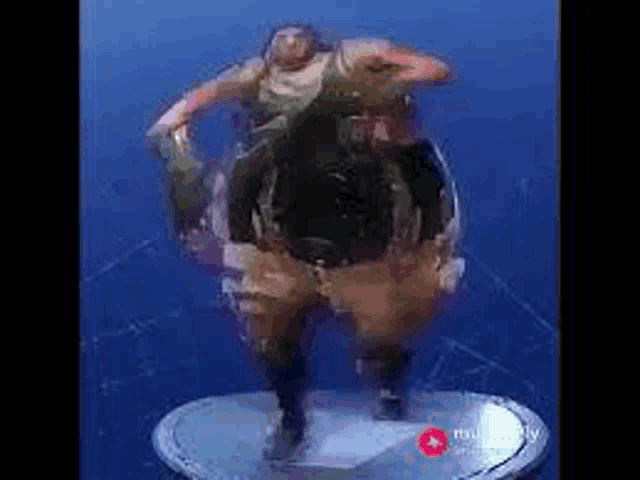 a statue of a man dancing in a video game on a pedestal .