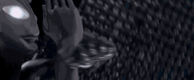 a close up of a person 's hand holding a lightning bolt in the dark .