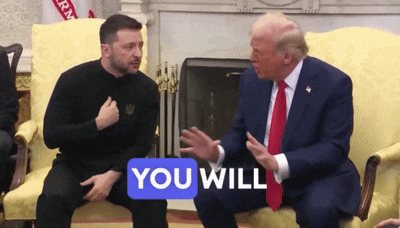 two men are sitting on a couch and one of them has a sticker that says " you will "