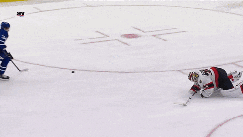 a hockey game is being played in front of a tim hortons ad