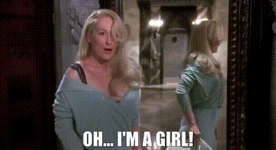 a woman is looking at herself in a mirror and says oh i 'm a girl .