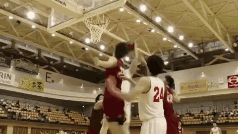 a basketball player with the number 24 on his jersey is jumping to catch the ball