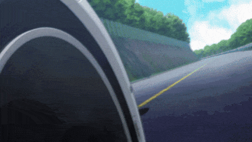 a car is driving down a road with a yellow line on the right