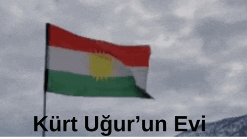 a kurdish flag with the words kurt ugur 'un evi written below it