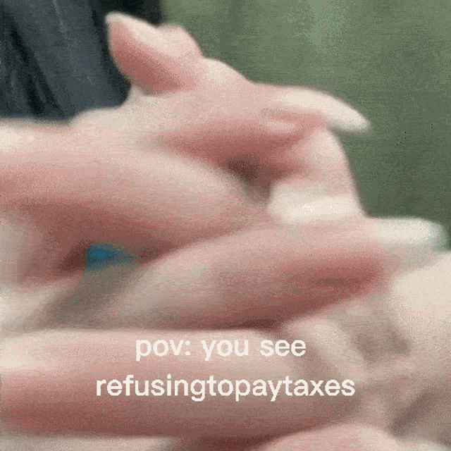 a close up of a person 's hands with the words pov you see refusing to pay taxes