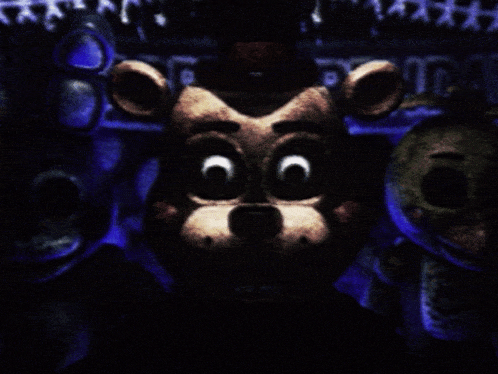 a teddy bear with big eyes is surrounded by other teddy bears and a sign that says ' freddy ' on it