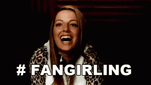 a woman is laughing with her mouth open and the words `` fangirling '' written in white .
