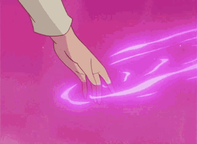a person 's hand is reaching out to touch a pink surface