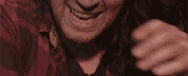 a close up of a man 's face with his hand on his face .