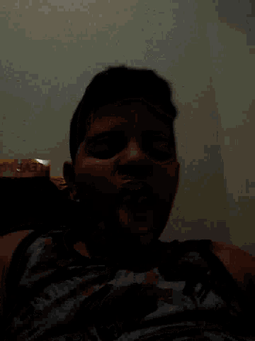 a young boy is sticking his tongue out while wearing a shirt that says ' avengers ' on it