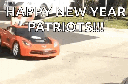 a red sports car is driving down a street with the words `` happy new year patriots !!! '' written on it .