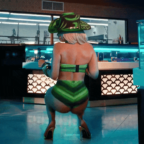 a woman in a green bikini and hat is dancing in front of a counter that says addiction paddles