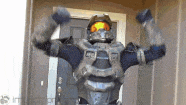 a man in a halo costume flexing his muscles in front of a door