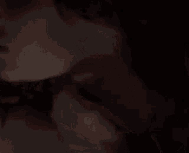 a close up of a person 's hands holding another person 's face .