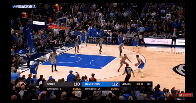 a basketball game is being played between the spurs and mavericks