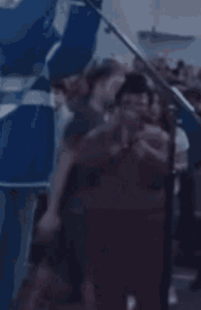 a blurry picture of a group of people standing around a microphone