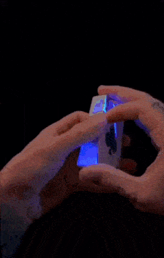 a person 's hand is holding a piece of cake that has a dollar sign on it