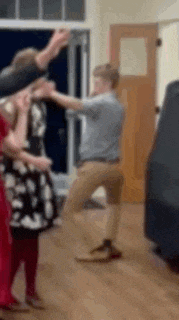 a blurry picture of a group of people dancing in a room