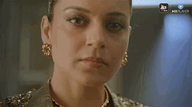 a close up of a woman 's face with the alt max logo in the corner