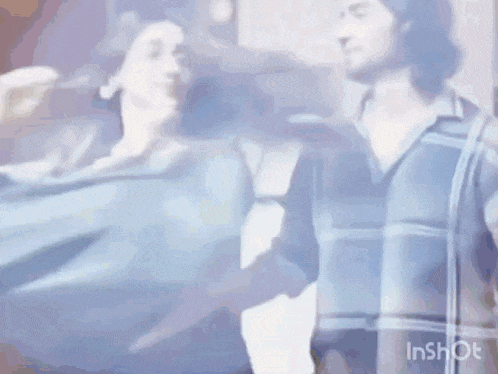 a man and a woman are standing next to each other and dancing .